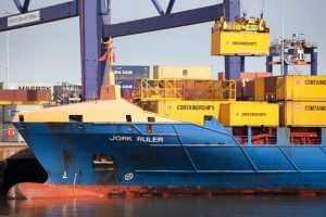 Professional commercial photography shot showing containers being loaded onto a ship at Teesport. Shot by professional northeast commercial photographer Cal Carey.