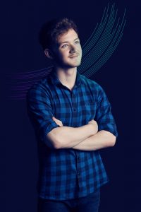 This is an advertising shot of a student being photographed in a studio style photograph featuring electric graphics for the company Baltic Training which is based around the Northeast of England.