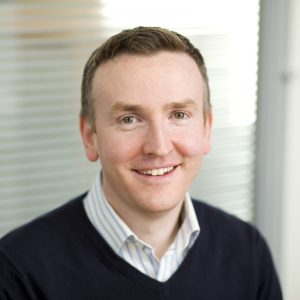 This is a corporate portrait shot, being taken in an office setting of an employee from Quorn Foods.