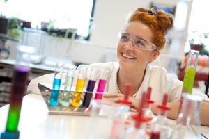 Professional advertising shot showing a young student enjoying, what looks like, a chemistry lesson. Shot by professional northeast advertising photographer Cal Carey.