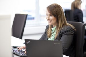A portrait photograph of a female member of staff at Greenbank working on a computer. Shot by professional northeast commercial photographer Cal Carey.