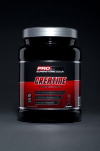 A professional studio product shot of a Protein Superstore vitamin and bodybuilding supplement. Photographed by Cal Carey the professional advertising photographer in his studio in Saltburn by the Sea, Teesside, Northeast UK. Shot on a graduated grey to black background with simple shadowing and vibrant colours.
