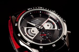 This a studio style photograph shot by Cal Carey, it is a detail shot of the watches mechanics and its clean design.