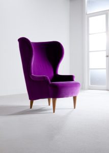 A purple Barker & Stonehouse armchair, lamp and sofa in a light room set.