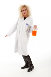 Professional advertising photography shot showing a woman dressed as a mad scientist as part of a marketing campaign for Odyssey Systems. Shot by professional northeast advertising photographer Cal Carey.