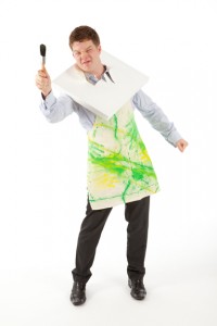 Professional advertising photography shot showing an artist with a broken canvas around his neck. Shot on a white background for a marketing campaign for Odyssey Systems. Shot by professional northeast advertising photographer Cal Carey.