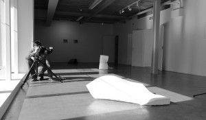 Black and white behind the scenes shot showing Cal Carey Photographer shooting a piece of art.