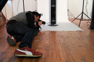 Behind the scenes photography showing Cal Carey Photographer shooting an Ebac water cooler on a white background in his studio.