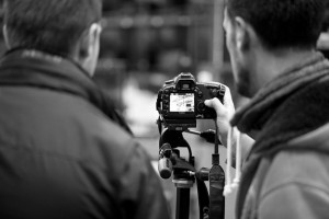 Black and white behind the scenes shot showing Cal Carey Photographer and a client reviewing an image on the screen of the DSLR camera.