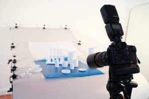 Behind the scenes photography shot showing the setup for the shoot with the camera in the foreground and in focus.