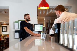 Professional commercial photography shot showing an Odyssey member at a hotel bar where they are install an odyssey system. Shot by professional northeast commercial photographer Cal Carey.