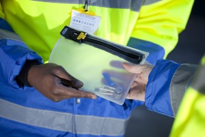 Professional commercial shot showing hand of each Vistech security guards (two). They are passing over a plastic wallet with keys. Shot by professional northeast commercial photographer Cal Carey.
