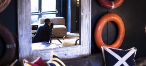 Behind the scenes shot showing the reflection Cal Carey the professional advertising photographer in a mirror whilst shooting for Barker & Stonehouse.