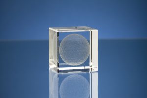 Professional product photography shot showing a glass cube manufactured by Crystal Galleries, on a blue background. Shot by professional northeast product photographer Cal Carey.