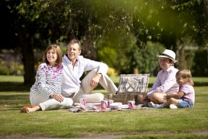Professional advertising photography shot showing a family of four at a picnic together. Shot by professional northeast commercial photographer Cal Carey.