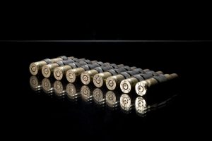 Conceptual photography shot showing a row of bullets on a black background. Shot by professional northeast photographer Cal Carey.