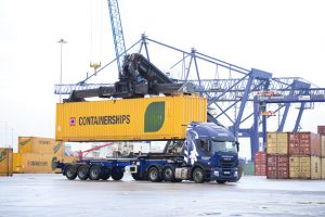 Professional commercial photography shot showing PD Ports new lorry on the docks, getting a container placed onto it. Shot by professional northeast commercial photographer Cal Carey.