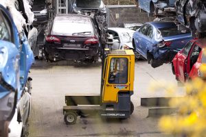Professional industrial photography shot showing the forklist between two of the car stack about to lift one of the cars down. Shot by professional northeast industrial photographer Cal Carey.