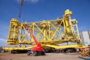 In this shot you can see there is of a vibrant yellow undersea machine used for putting wind turbines into the seabed. Shot by professional northeast commercial industrial photographer Cal Carey.