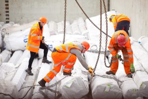 Professional industrial photograph showing PD Ports workers uploading steel cable from a ship on the River Trent. Shot by professional Northeast commercial and manufacturing photographer Cal Carey.