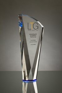 A studio photograph of a Crystal Galleries award shot on a grey backgroung with a horizon line behind the award.